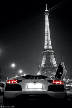 a sports car parked in front of the eiffel tower