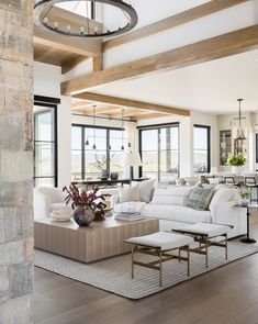 a living room with white couches and wooden beams on the ceiling is featured in instagram