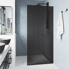 a black and white bathroom with a stand up shower