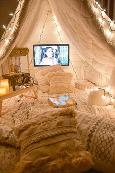 a bed room with a neatly made bed and a flat screen tv on the wall