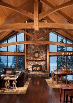 a living room filled with furniture and a fire place in the middle of a room