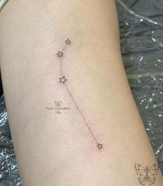 a small star tattoo on the thigh