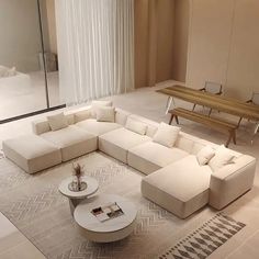 a modern living room with white couches and coffee table