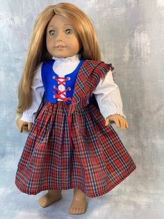 a doll with blonde hair wearing a red and blue dress