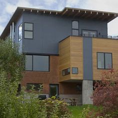 a large house sitting on top of a lush green hillside