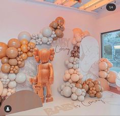 balloons are arranged in the shape of an astronaut's suit and helmet on display