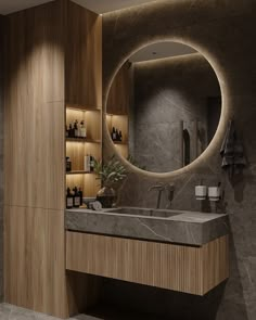 a bathroom with a sink, mirror and shelves on the wall next to each other