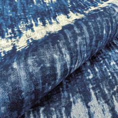 an upholstered blue and white area rug with different patterns on the fabric,