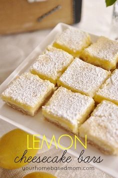 lemon cheesecake bars on a plate with lemons in the background and text overlay that reads lemon cheesecake bars