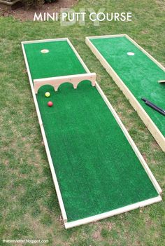 an outdoor miniature golf course with balls on the ground and a tee in the grass