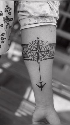 a person with a compass tattoo on their leg