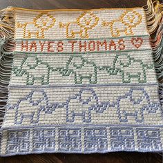 two crocheted placemats with elephants and the words have & thomas written on them