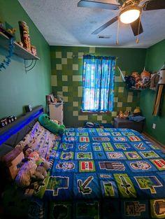 a bed room with a neatly made bed next to a window and a ceiling fan