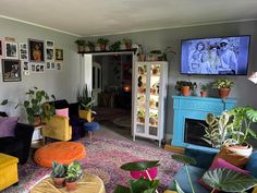 a living room filled with furniture and lots of plants