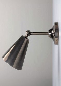 a wall mounted lamp on the side of a white wall