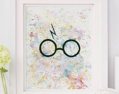 a framed harry potter symbol on a wall next to a vase with flowers in it