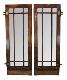 two wooden doors with mirrors on each side