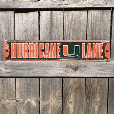 "University of Miami Sign University Miami Hurricanes Street Sign Miami Dorm Sign College Sign Dorm Room Decor Gifts for College Students -OFFICIALLY LICENSED University of Miami Hurricanes street sign - proudly MADE IN THE USA!  -Dimensions: approximately 24\" across x 5.5\" tall -This sign is made of .024\" embossed aluminum substrate, which will not rust (embossing is the process of creating raised areas or designs in the metal that create a three-dimensional effect) -Inks are lead free, and UV resistant so this sign is safe for indoor or outdoor use! -Light weight, single sided and all ready for hanging! For more great gifts, check out the rest of our shop!" Dorm In Out Door Signs, Miami Sign, Dorm Signs, Gifts For College Students, Room Decor Gifts, Michigan State University, University Of Miami, Street Sign, Street Signs