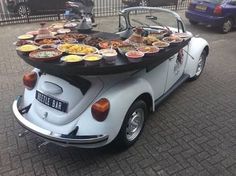 an old car with food on the back