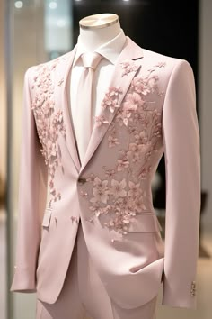 a pink suit with flowers on it and a white shirt in the background, sitting on a mannequin's head