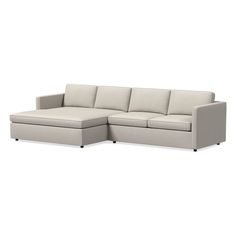 a white sectional couch sitting on top of a white floor