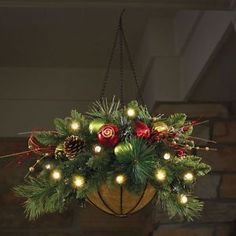 a hanging basket filled with christmas decorations and lights