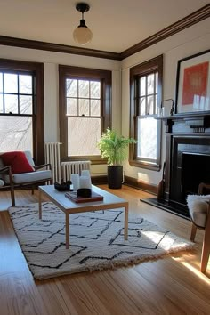 a living room filled with furniture and a fire place in the middle of a wooden floor