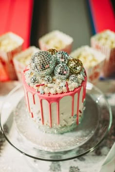 there is a cake that has been decorated with disco balls and candy on the top