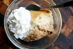 a glass bowl filled with dessert and whipped cream