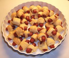 a white plate topped with pigs in a blanket