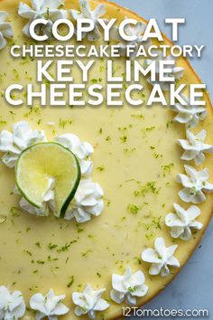 a key lime cheesecake with whipped cream on top and the words copycat cheesecake factory key lime cheesecake