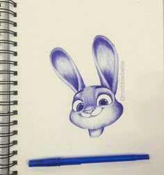 a pencil drawing of a rabbit with eyes wide open and ears straight up, sitting next to a blue pen