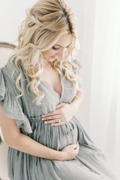 a pregnant woman is sitting on a chair