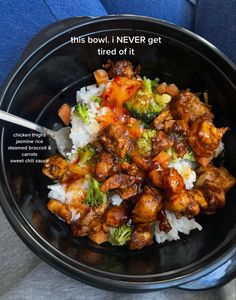 a black bowl filled with rice and meat