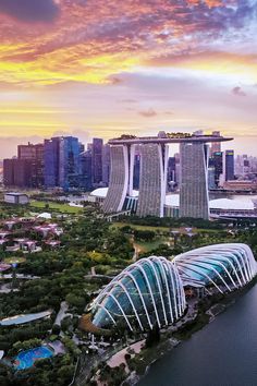 an aerial view of the gardens by the bay in singapore, with sunset behind it