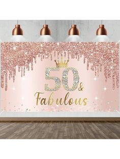 a pink and gold 50th birthday backdrop with the number fifty and fabulous written on it