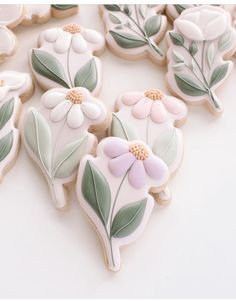 decorated cookies with flowers and leaves on them