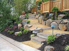 a garden with rocks and plants in it