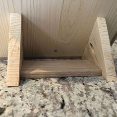 a wooden shelf sitting on top of a counter next to a marble countertopstone