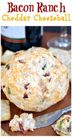 bacon ranch cheddar cheeseball on a cutting board with crackers and wine in the background