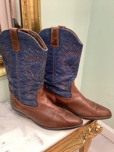 D E S C R I P T I O N Vintage Leather Billy Joe western cowboy boot. Beautiful Denim Upper detail. Size 8. Made in Spain. C O N D I T I O N Good vintage condition. Normal wear from age and use. Leather is supple and divine. S I Z E & M E A S U R E M E N T S Heel Height: 1.5 in  Outer sole width: 3.75 in Outer sole length: 10 in  Boot height: 11.25  in top of heel to top of boot Marked US 8  Authenticity Guarantee All items sold in our shop are 100% guaranteed authentic vintage or your money back. Custom Cowboy Boots Vintage, Luxury Vintage Cowboy Boots With Snip Toe, Luxury Hand-tooled Leather Cowboy Boots, Western Boots Yeehawcowboy.com, Luxury Hand-tooled Cowboy Boots For Ranch, Leather Denim, Western Cowboy Boots, Western Cowboy, Vintage Leather