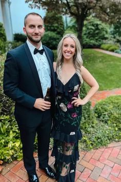 a man in a tuxedo standing next to a woman in a black dress