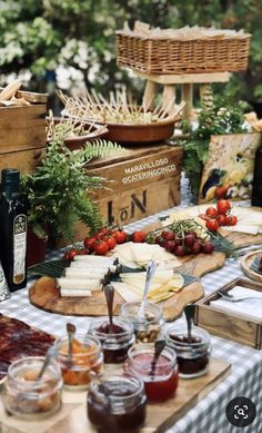 an assortment of cheeses, jams and other condiments on a table