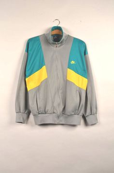 "Vintage nike 90s windbreaker in great condition WITH A SMALL HOLE SEE THE PICTURE. Size: M Material: NA Measurement: - Chest(armpit to armpit: 57(22.4\") - Length from the backside(Center bottom of the collar to center bottom of the garment): 64cm(25.2\") -Shoulder to shoulder seam:59(23.2\") - Shoulder seam to end of cuff:52(20.4\") NOTE: Because of the age, clothing can shrink or the sizing from that time wasn't the same as the size from modern clothing. Make sure you have checked our measure Nike 90s Vintage Track, Nike Vintage Windbreaker, 1990 Nike Sweater, Nike Vintage Track Jacket, Nike Windbreaker Jacket Vintage, 90s Windbreaker, Nike Track Jacket, Nike Vintage, Vintage Long-sleeve Nylon Track Jacket