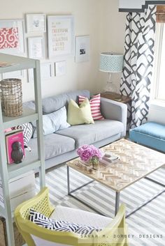 a living room filled with furniture and pictures on the wall