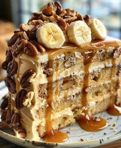 a piece of cake with bananas and pecans on top is drizzled with caramel