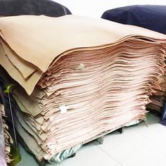 a pile of folded papers sitting on top of a blue chair