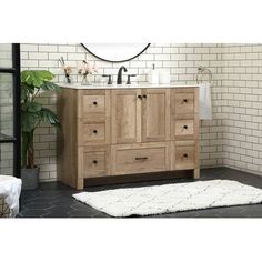 a bathroom with a white rug on the floor and a wooden cabinet in front of it