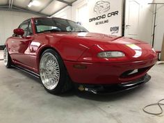 a red sports car parked in a garage