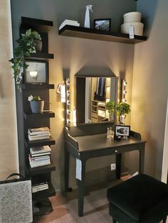 a room with a desk, mirror and shelves on the wall next to a chair